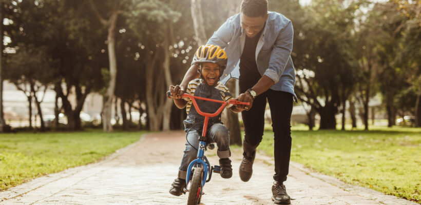 Boy,Learning,To,Ride,A,Bicycle,With,His,Father,In